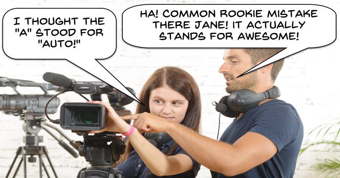 Cameraman, mansplianing auto settings to female student.