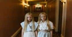 Cinematic shot of twins in a hallway.