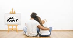 Couple looking at a wall watching paint dry.