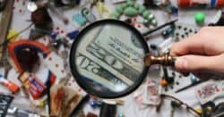 Image of magnifying glass over assorted objects on a table.