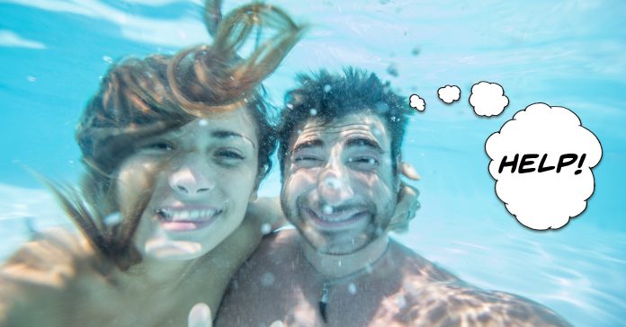 Image of couple under water taking a selfie